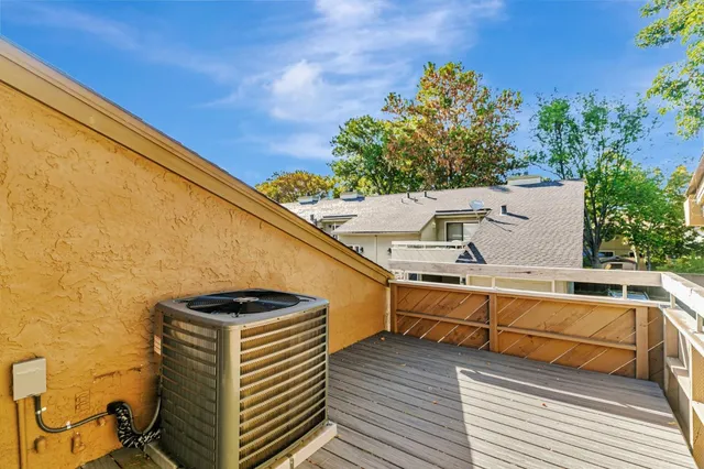 a view of a balcony with wooden floor and fence