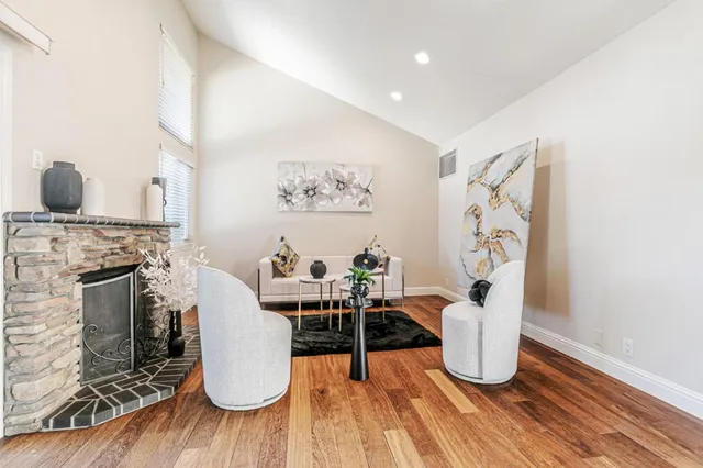 a living room with furniture and a fireplace