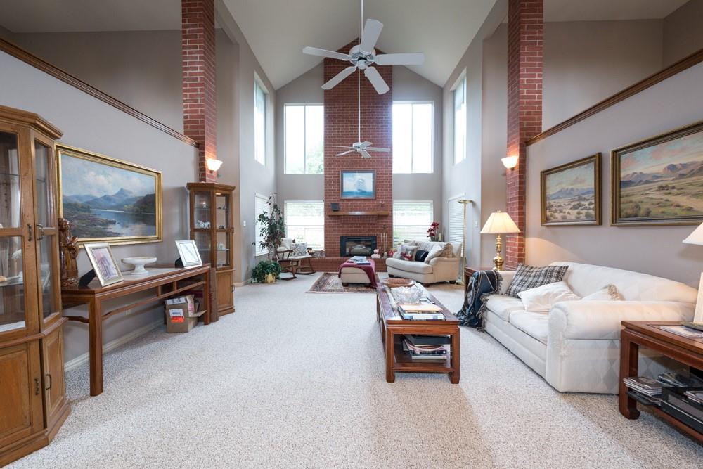 9554 David Fort Road Argyle, TX 76226 - Photo 15 of 35 a living room with furniture and a chandelier