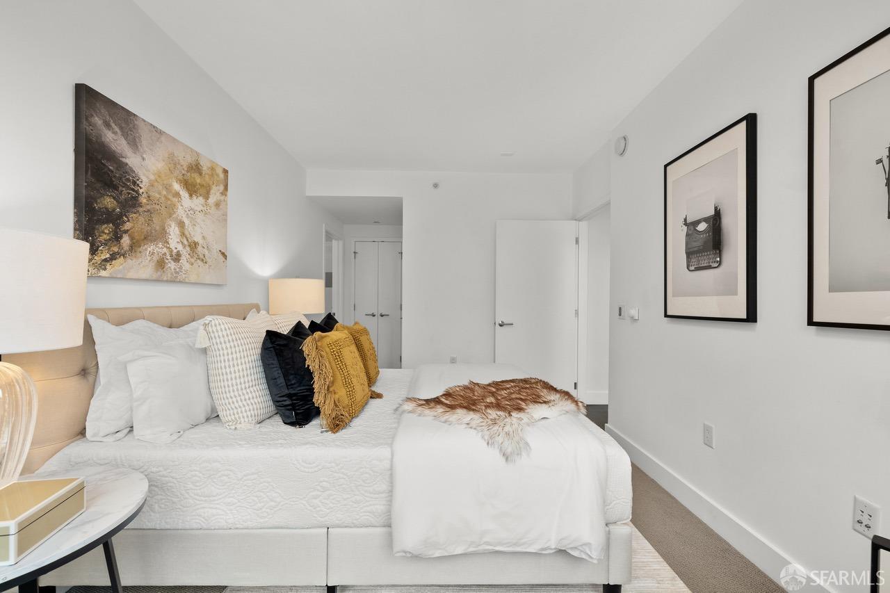 8 Buchanan Street, Unit 200L San Francisco, CA 94102 - Photo 12 of 27 a bedroom with a bed and painting on the wall
