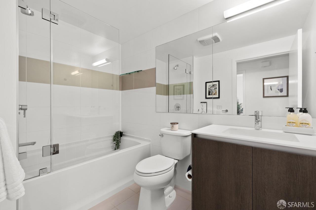 8 Buchanan Street, Unit 200L San Francisco, CA 94102 - Photo 17 of 27 a bathroom with a toilet a sink a mirror a bathtub and vanity