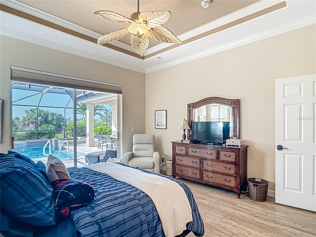 114 Rimini Way North Venice, FL 34275 - Photo 14 of 54 a spacious bedroom with a bed and wooden floor