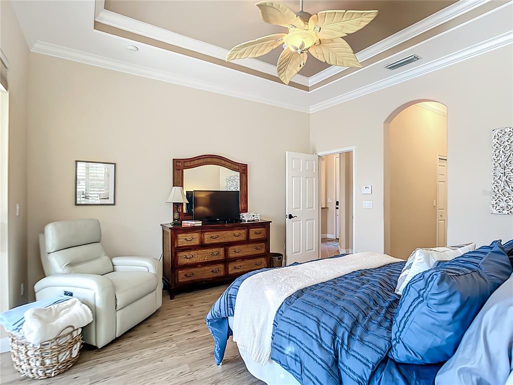 114 Rimini Way North Venice, FL 34275 - Photo 15 of 54 a bedroom with furniture and wooden floor