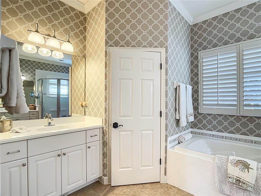 114 Rimini Way North Venice, FL 34275 - Photo 16 of 54 a bathroom with a tub sink and mirror