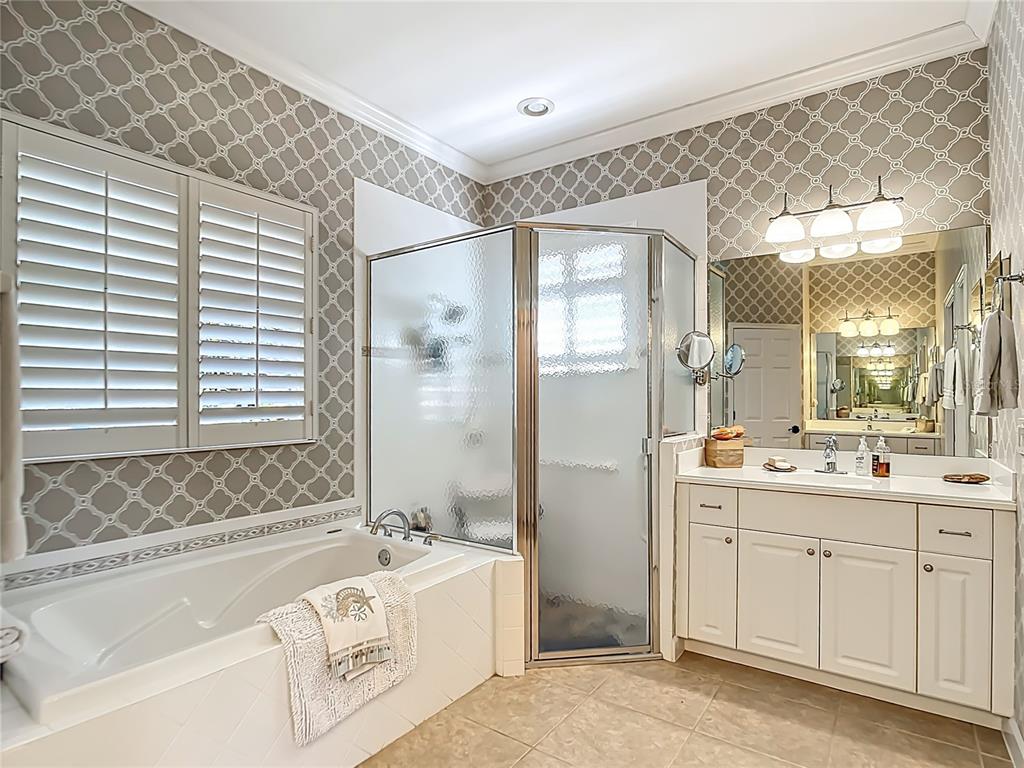 114 Rimini Way North Venice, FL 34275 - Photo 17 of 54 a bathroom with a tub sink and mirror