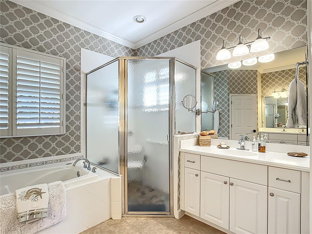 114 Rimini Way North Venice, FL 34275 - Photo 18 of 54 a bathroom with a double vanity sink mirror and bathtub