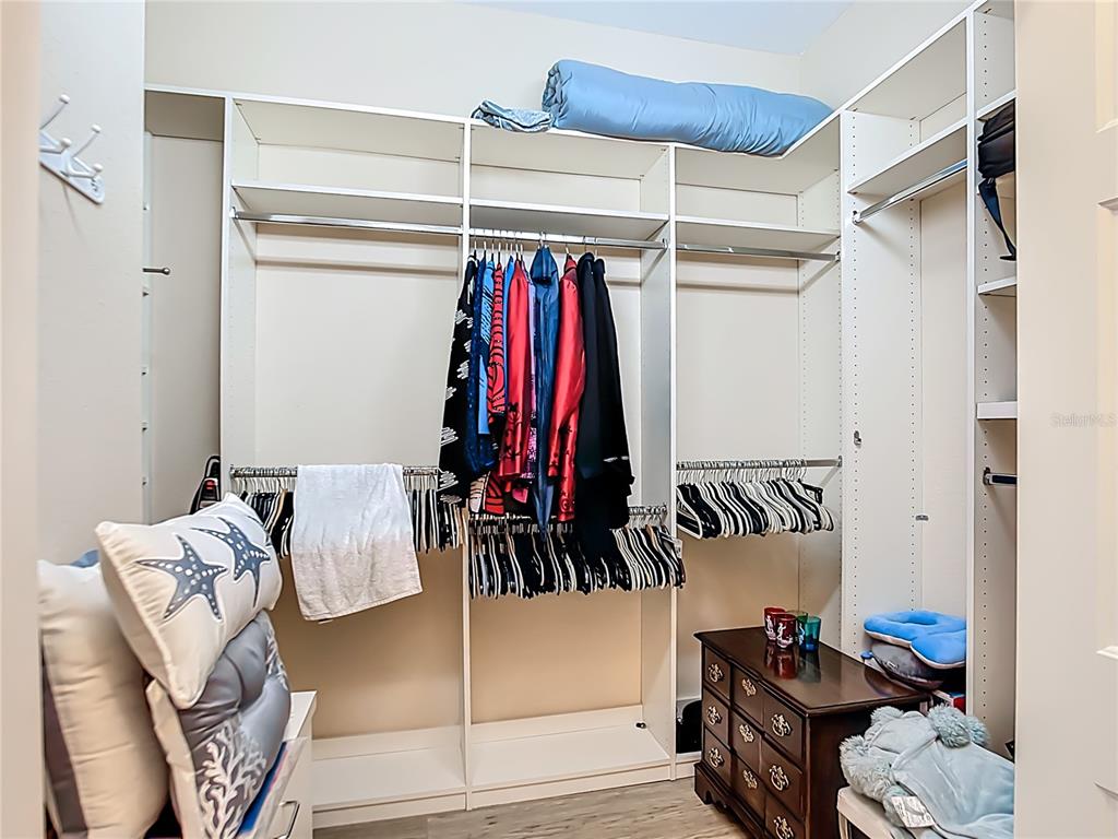 114 Rimini Way North Venice, FL 34275 - Photo 19 of 54 a view of walk in closet with clothes and shoes