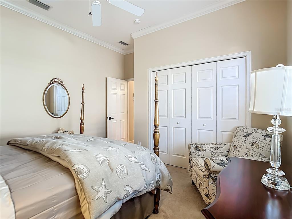 114 Rimini Way North Venice, FL 34275 - Photo 23 of 54 a bedroom with bed and a chandelier
