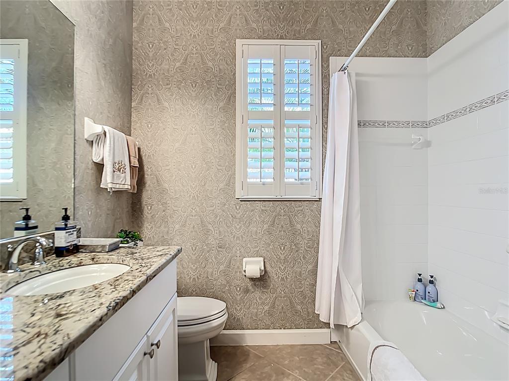 114 Rimini Way North Venice, FL 34275 - Photo 24 of 54 a bathroom with a granite countertop sink toilet and shower