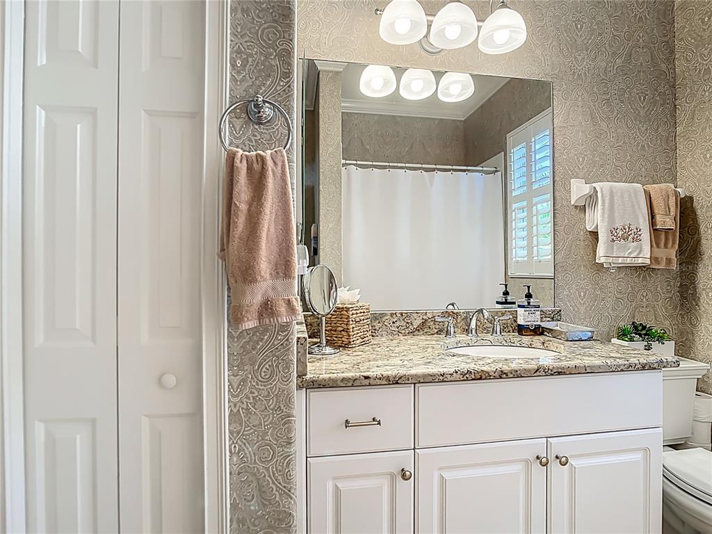 114 Rimini Way North Venice, FL 34275 - Photo 26 of 54 a bathroom with a sink and a mirror