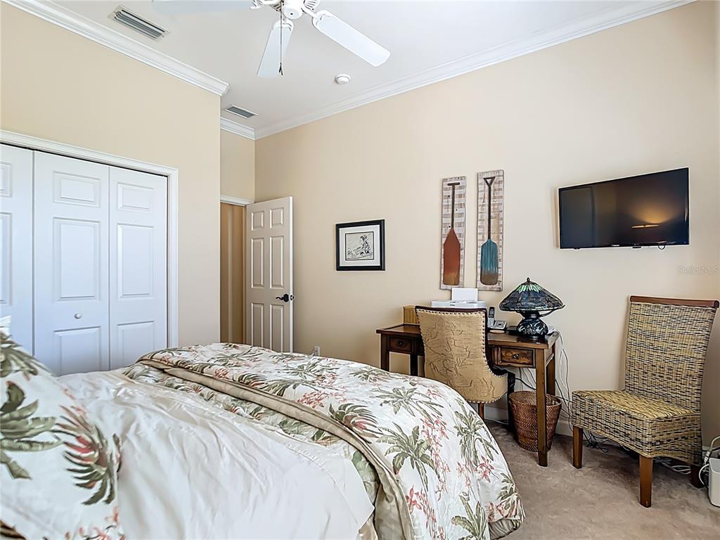 114 Rimini Way North Venice, FL 34275 - Photo 28 of 54 a bedroom with a bed and a flat screen tv