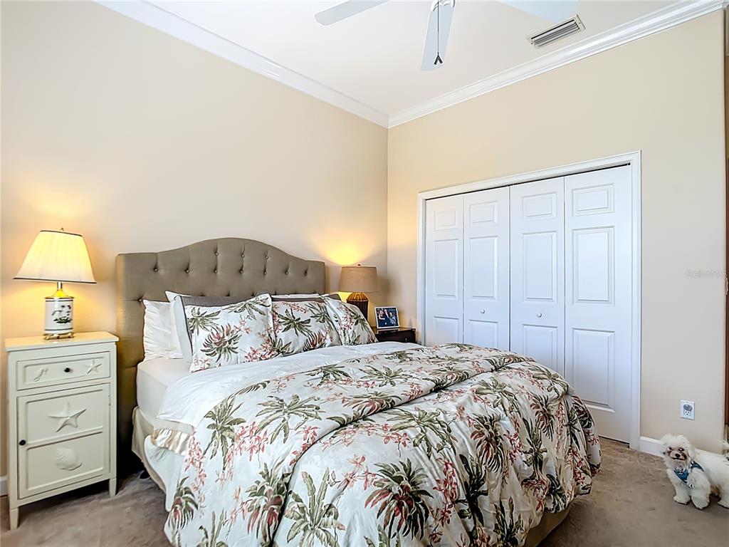 114 Rimini Way North Venice, FL 34275 - Photo 29 of 54 a bedroom with a bed and a lamp on dresser