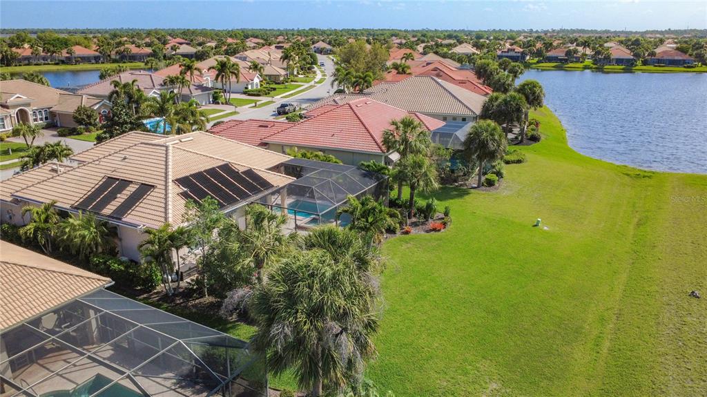 114 Rimini Way North Venice, FL 34275 - Photo 38 of 54 an aerial view of a house with a garden and lake view