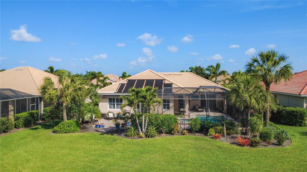 114 Rimini Way North Venice, FL 34275 - Photo 40 of 54 a front view of a house with a yard patio and fire pit