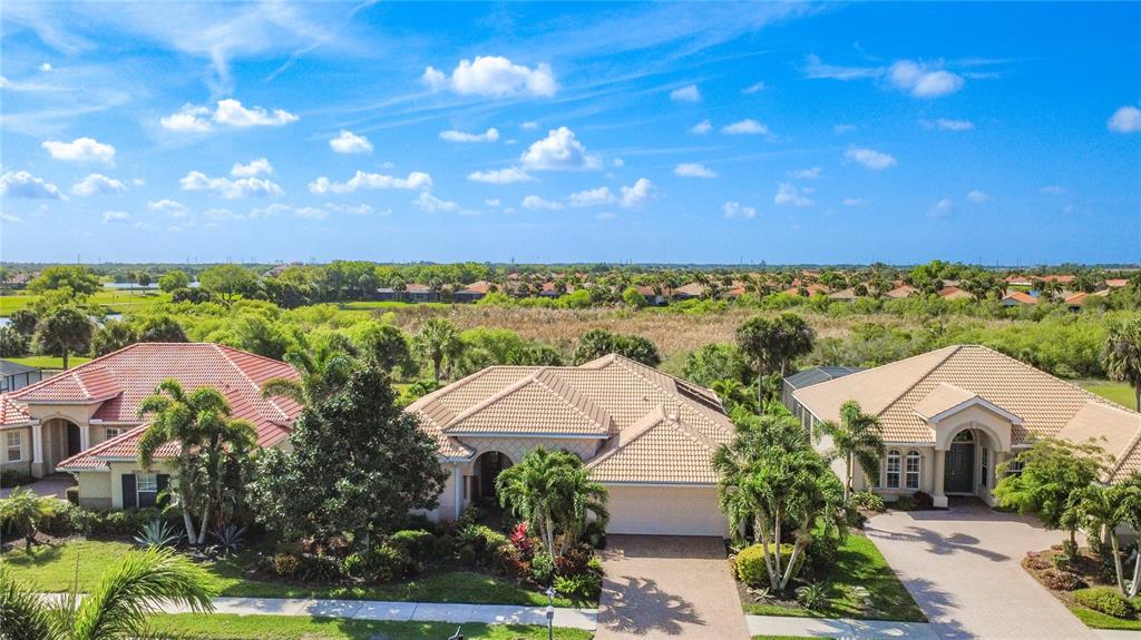 114 Rimini Way North Venice, FL 34275 - Photo 46 of 54 an aerial view of residential houses with outdoor space and trees