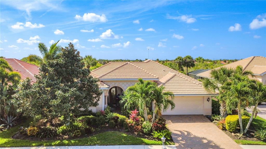 114 Rimini Way North Venice, FL 34275 - Photo 48 of 54 a view of a house with a yard and potted plants
