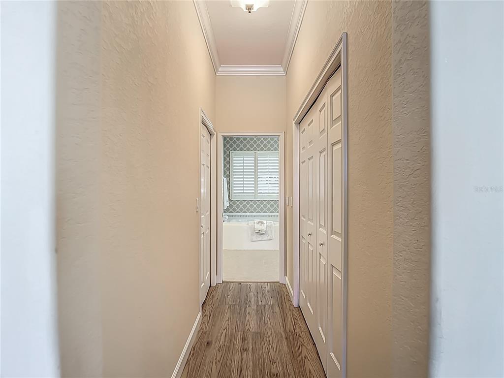 114 Rimini Way North Venice, FL 34275 - Photo 50 of 54 a view of a hallway with wooden floor and a bathroom