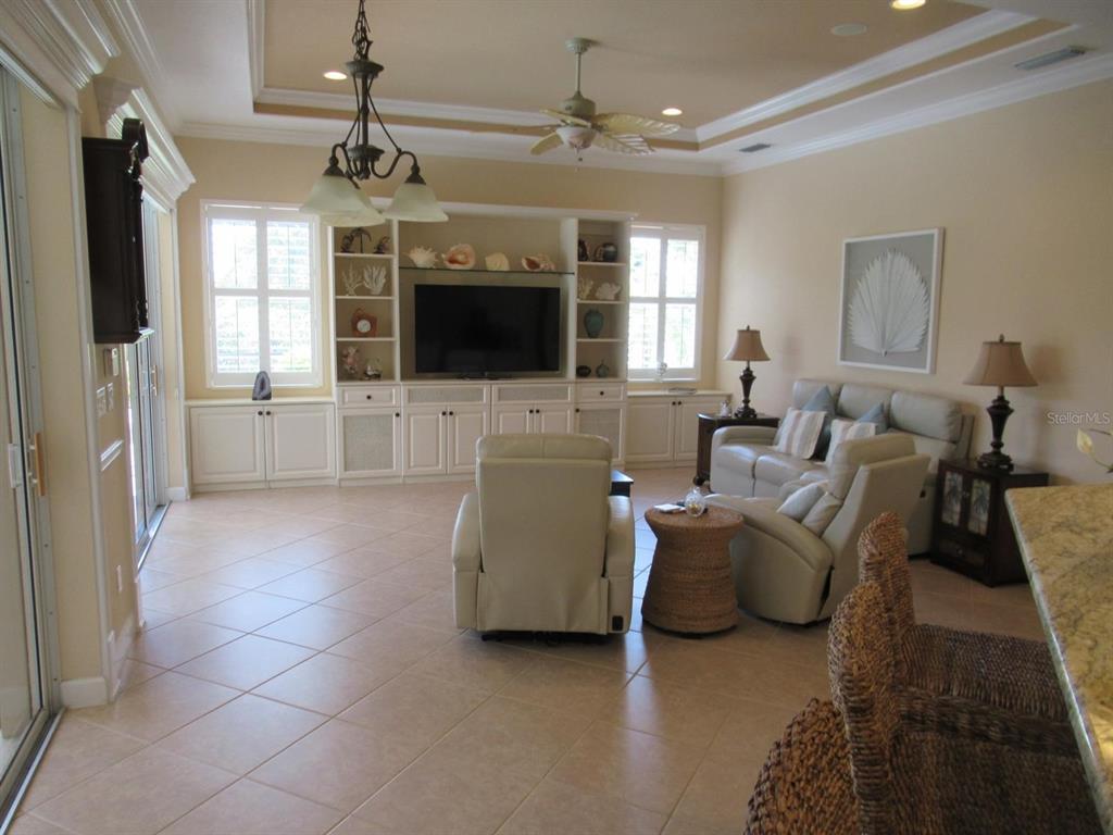 114 Rimini Way North Venice, FL 34275 - Photo 5 of 54 a living room with furniture and a flat screen tv