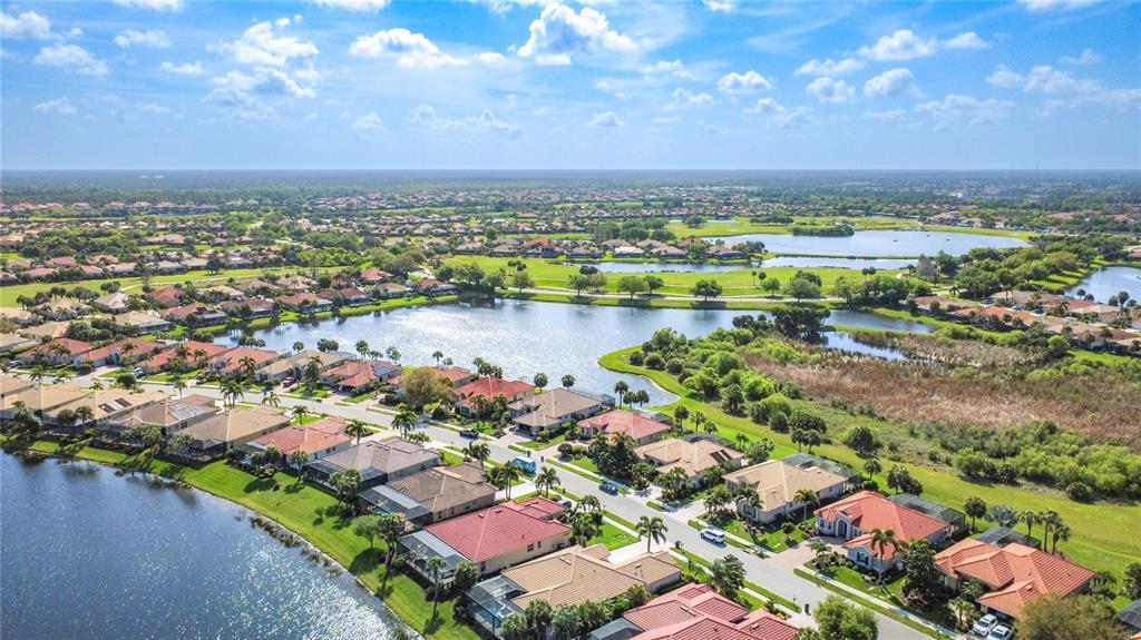 114 Rimini Way North Venice, FL 34275 - Photo 51 of 54 a view of a city with lots of lake and houses in the back