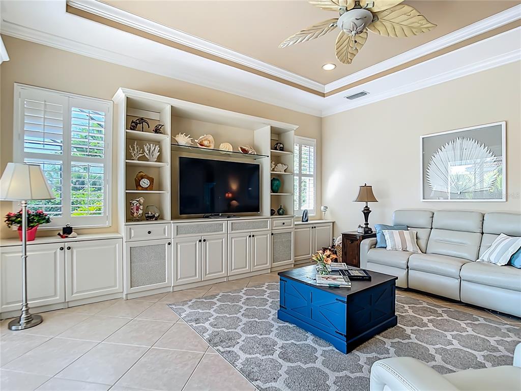 114 Rimini Way North Venice, FL 34275 - Photo 8 of 54 a living room with furniture a flat screen tv and a window