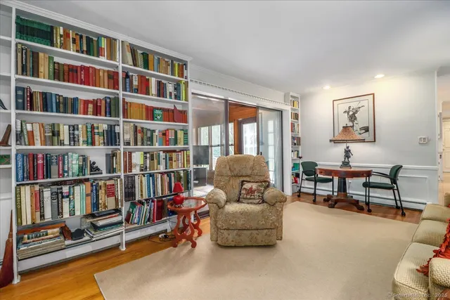 a living room with furniture and a book shelf