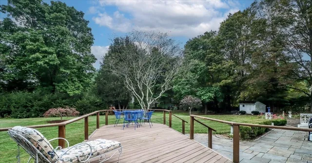 a view of house with outdoor seating and green space