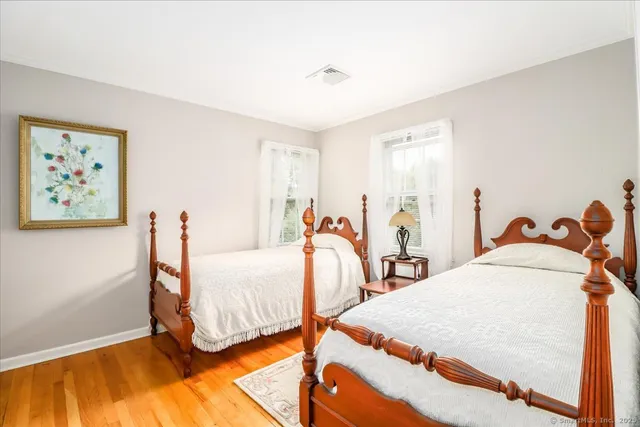 a bed room with two beds and a desk