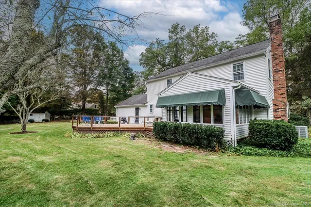 a view of a house with a yard and sitting area