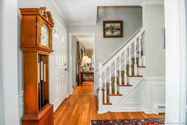 a view of entryway and hall with wooden floor