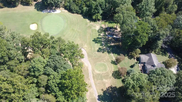 an aerial view of a house with yard