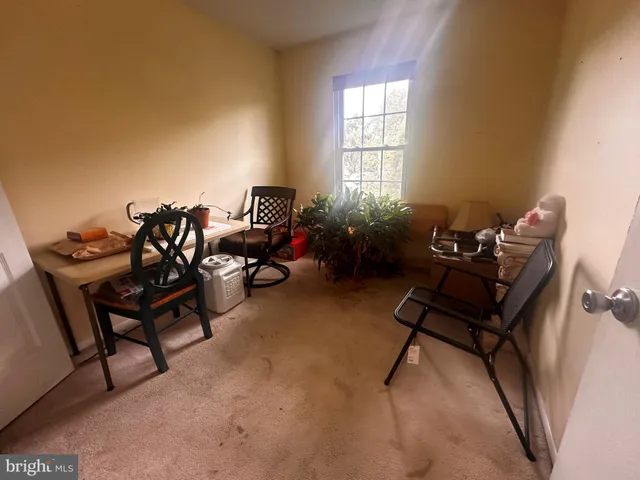 a living room with furniture a air conditioner vent and a window