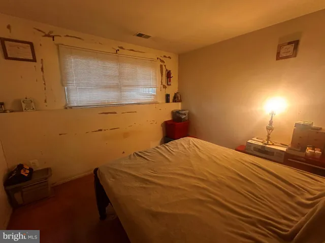 a bed sitting in a bedroom next to a bathroom