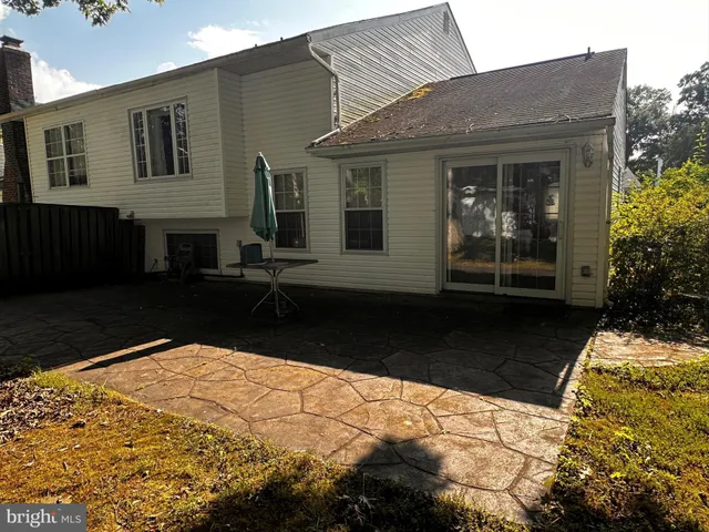 a view of house with backyard
