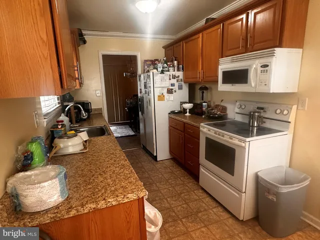 a kitchen with sink refrigerator and stove