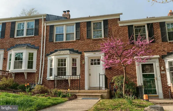 front view of a brick house with a yard