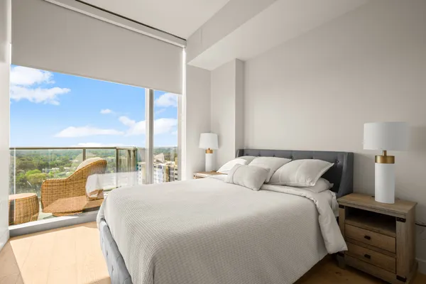 a bedroom with a large bed and a large window