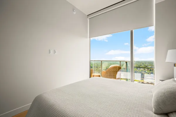 a bedroom with a large bed and a window