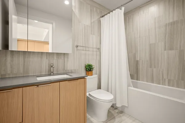 a bathroom with a sink a toilet and tub