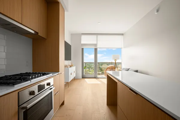 a kitchen with a sink stove and cabinets