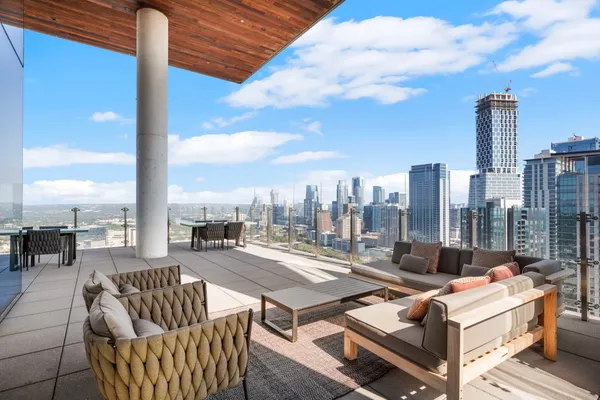 a terrace with outdoor seating and city view