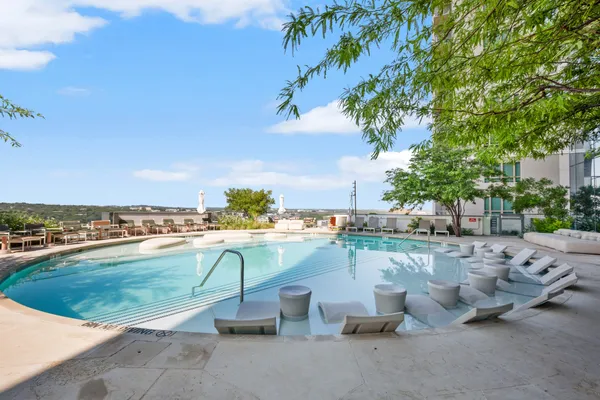 a view of a swimming pool and lounge chair