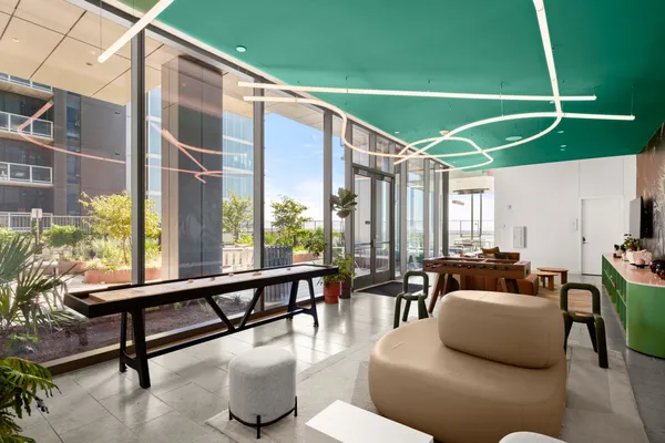 a living room with furniture and a floor to ceiling window