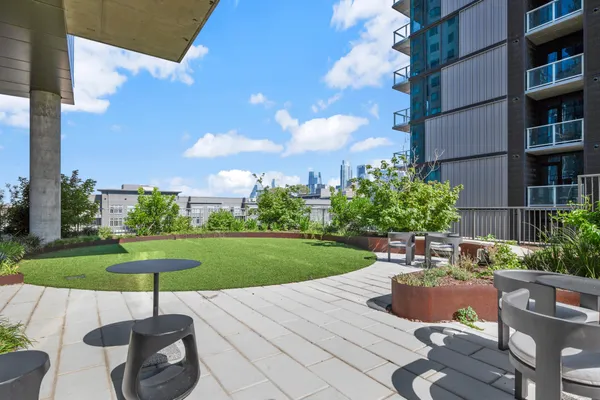 a swimming pool with outdoor seating and plants