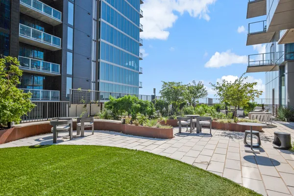 a view of a patio with a table and chairs and potted plants