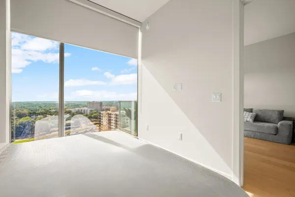 a view of a living room hardwood floor and a large window
