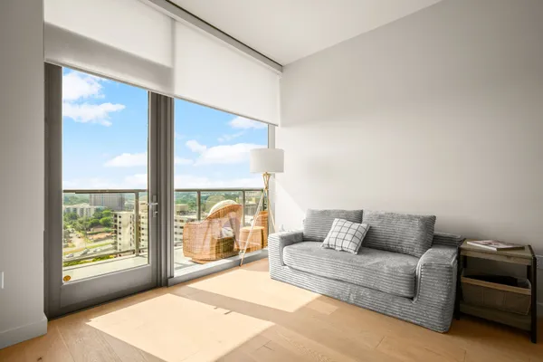 a living room with furniture and a large window