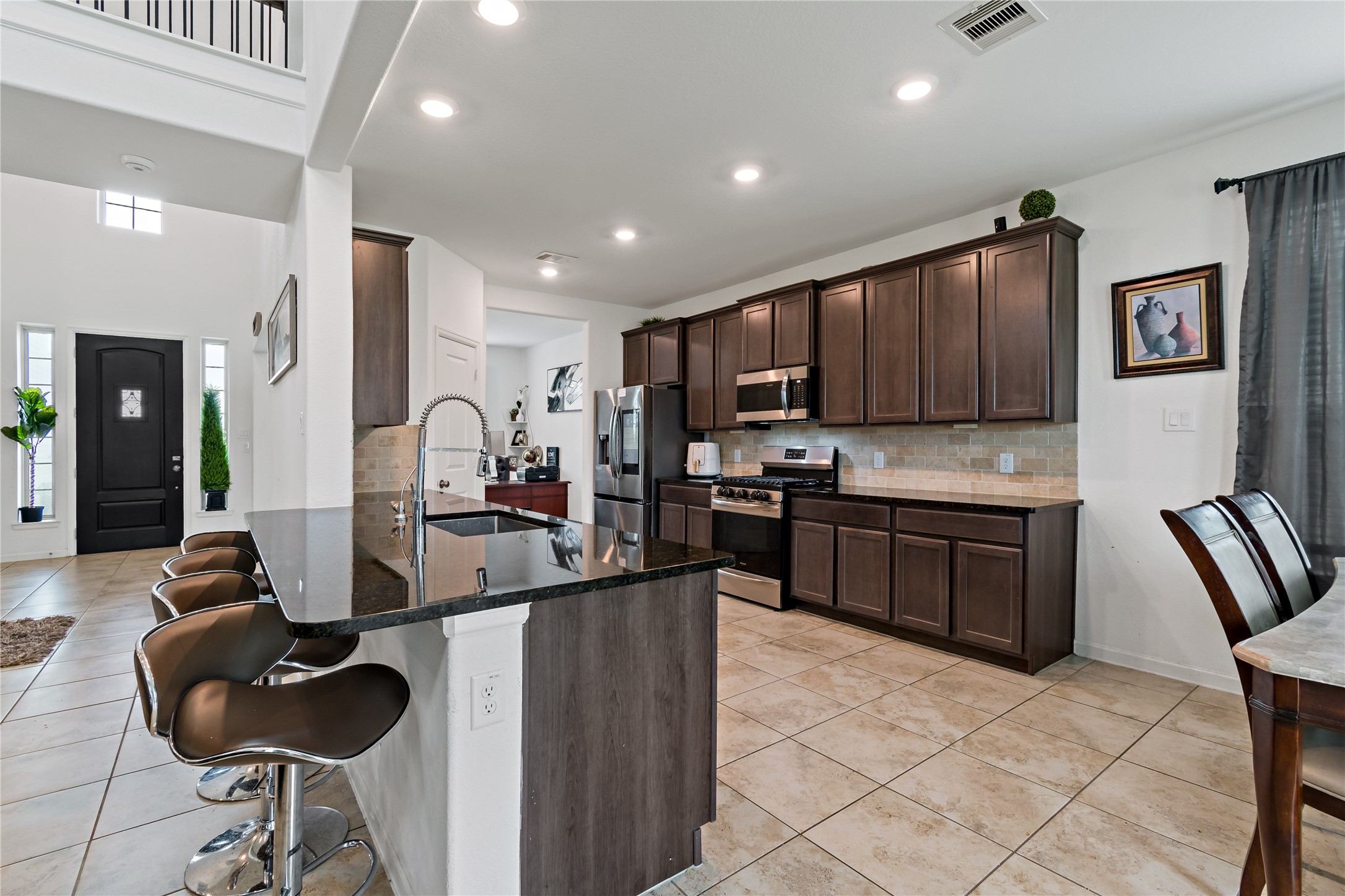 14010 Hartford Heights Way Rosharon, TX 77583 - Photo 19 of 30 a kitchen with sink refrigerator and cabinets