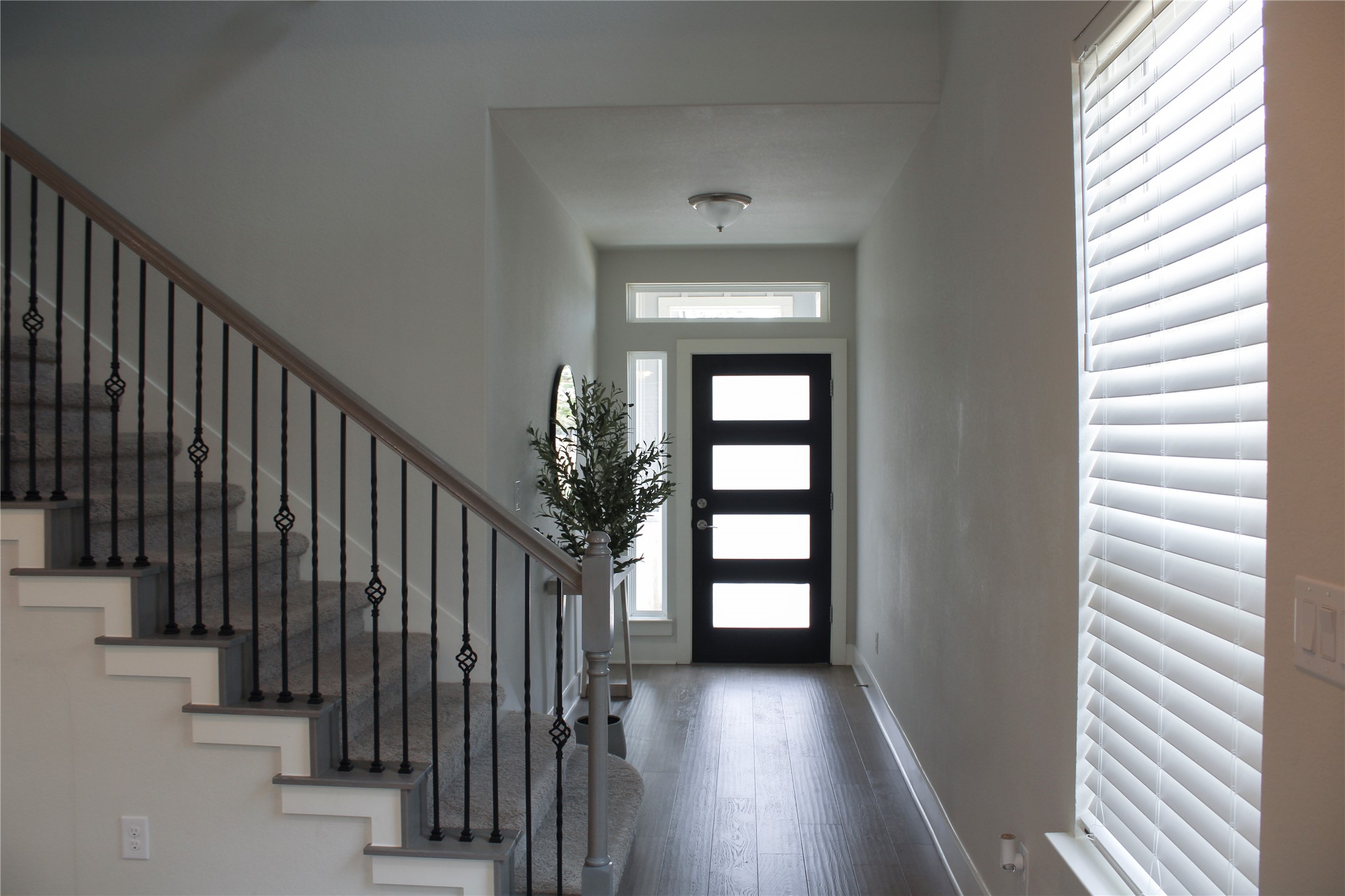 1007 Harwell Loop Kyle, TX 78640 - Photo 23 of 40 a view of a hallway with wooden floor and stairs