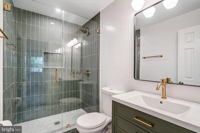 a view of empty room with window and wooden floor