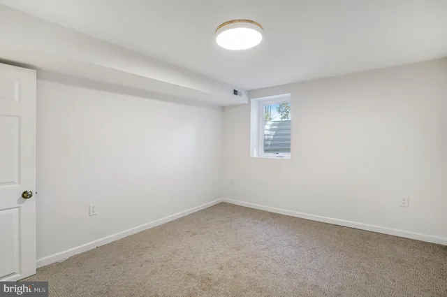an empty room with a empty space and window
